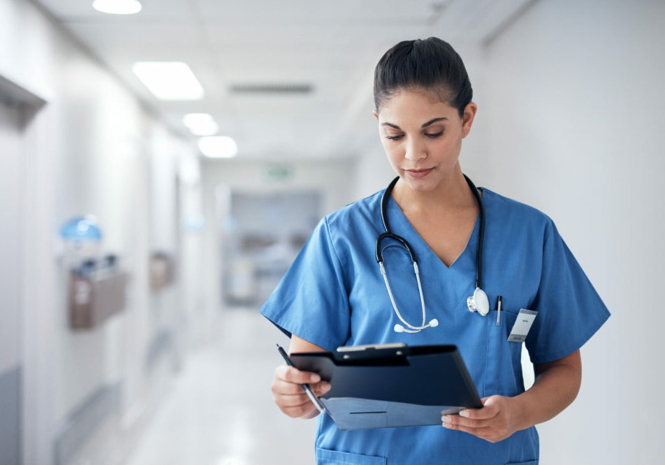 Cropped shot of an attractive young female nurse going through medical records while working in the hospital