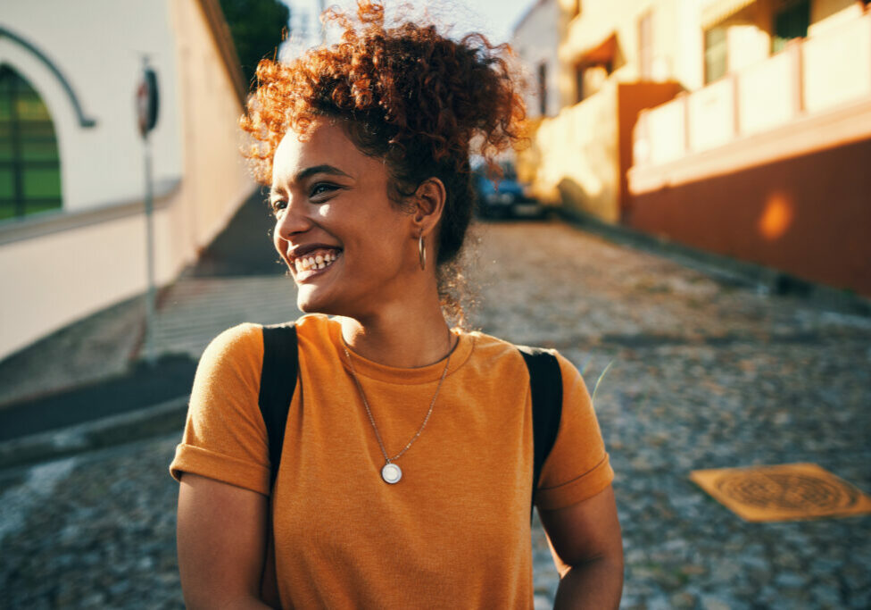 Cropped shot of an attractive young woman standing alone during a day out in the city