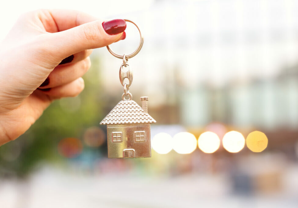 Real estate concept with home keys in hand